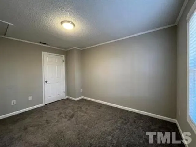 an empty room with a empty space and windows