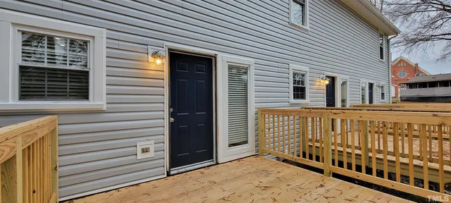 a view of deck with hardwood and trees