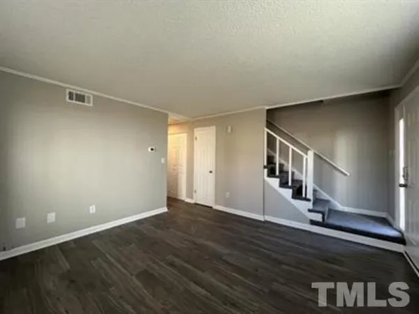 a view of an entryway with wooden floor