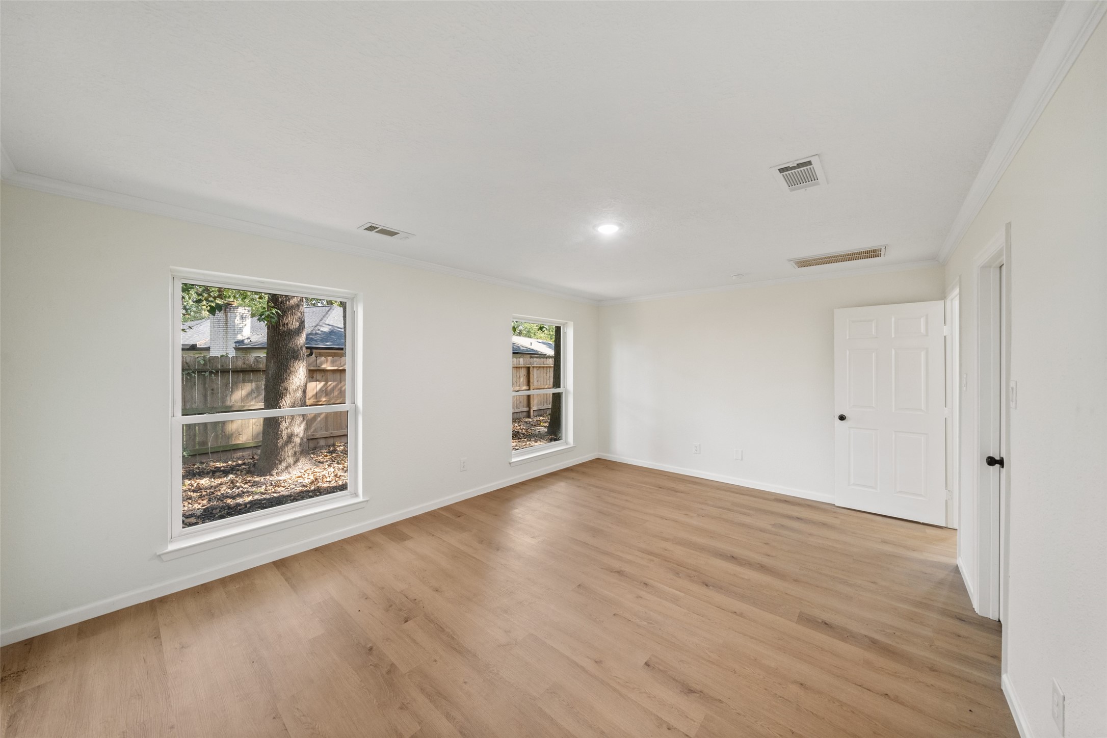 238 Point Clear Drive Conroe, TX 77304 - Photo 9 of 20 an empty room with wooden floor and windows