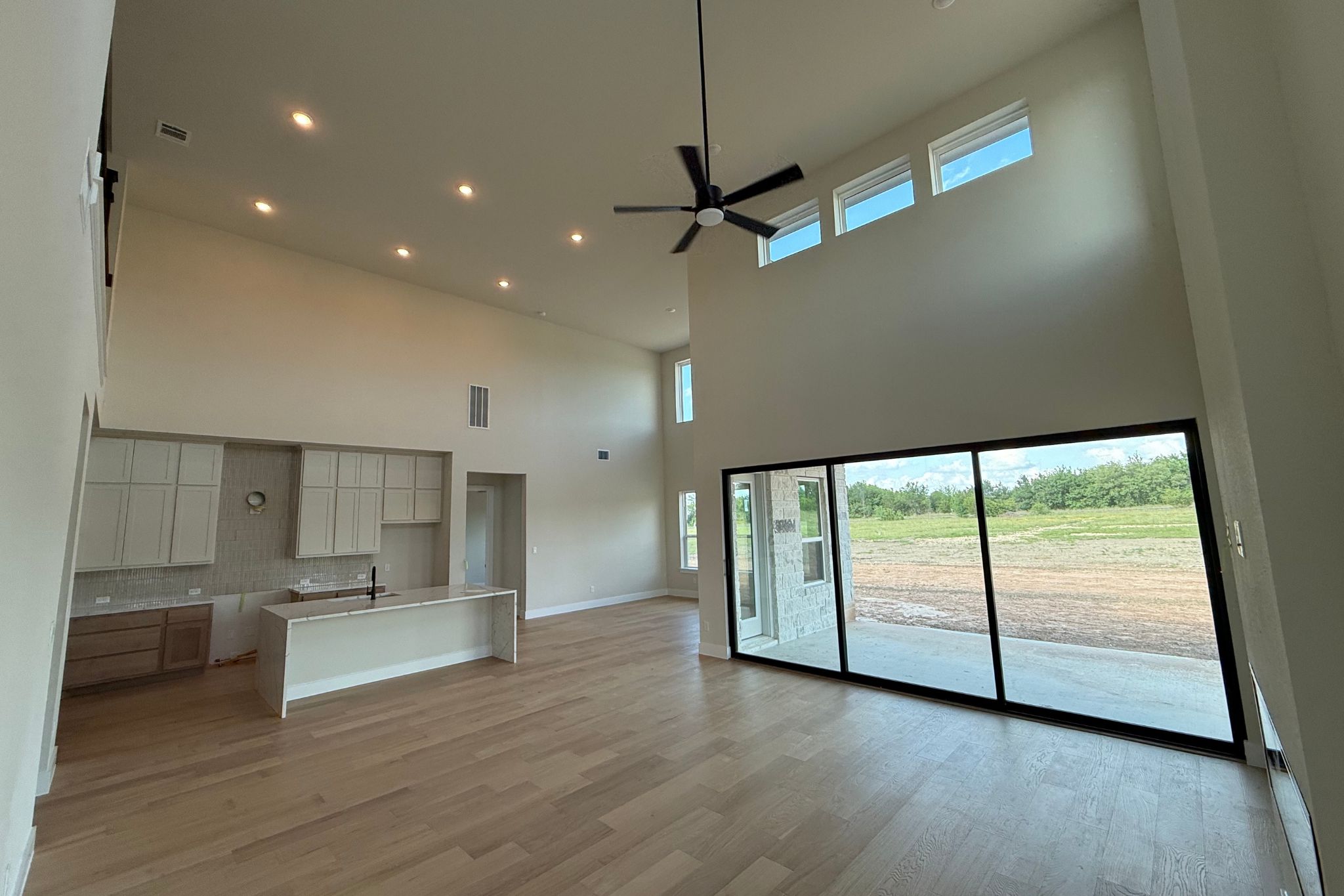 1412 Paxton Lane Georgetown, TX 78633 - Photo 4 of 14 a view of an empty room with a window and wooden floor