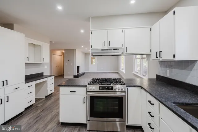 a kitchen with stainless steel appliances a stove a sink and a refrigerator