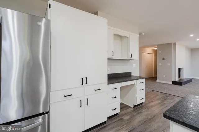 an empty room with fan and windows