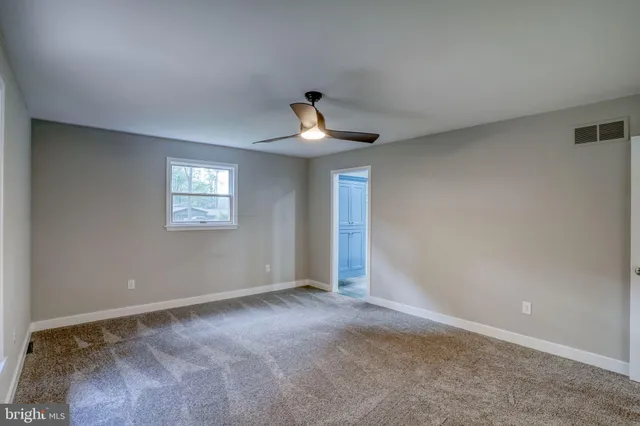 a bathroom with a granite countertop double vanity sink toilet and shower