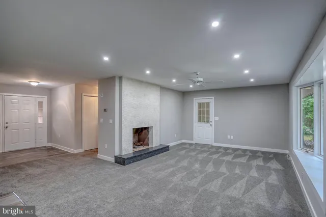 a large open kitchen with a refrigerator a stove top oven and white cabinets