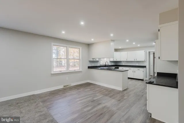 a kitchen with stainless steel appliances granite countertop a stove and a refrigerator
