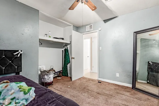 a bedroom with bed and wooden floor