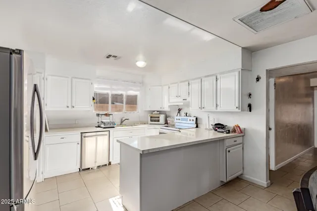 a kitchen with a sink stove and refrigerator