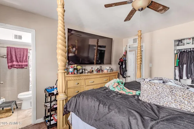 a bedroom with a bed and a flat screen tv