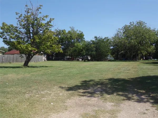 a view of a street with a building in the background