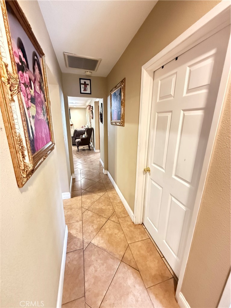 1014 North Daisy Avenue Santa Ana, CA 92703 - Photo 16 of 27 a view of a hallway to a livingroom with wooden floor and furniture