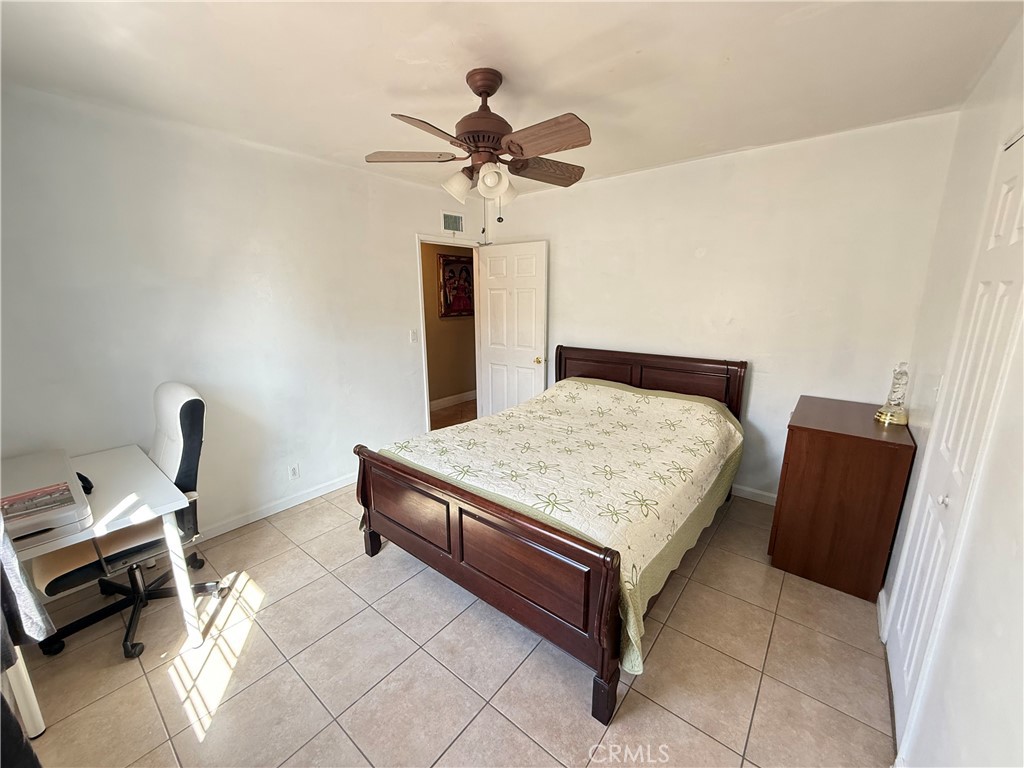 1014 North Daisy Avenue Santa Ana, CA 92703 - Photo 19 of 27 a bedroom with a bed and a chandelier