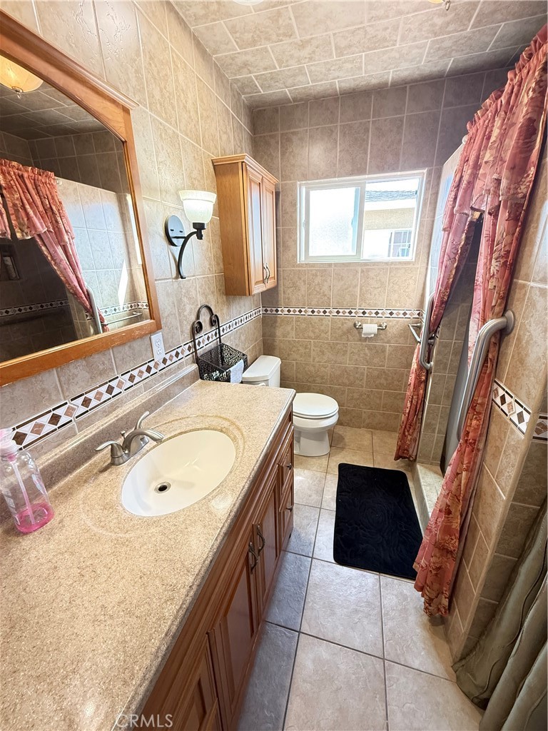 1014 North Daisy Avenue Santa Ana, CA 92703 - Photo 23 of 27 a bathroom with a granite countertop sink and a mirror