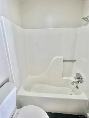 a bathroom with a bathtub and toilet