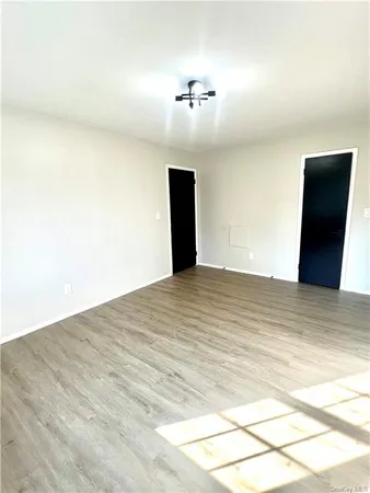 a view of a room with wooden floor