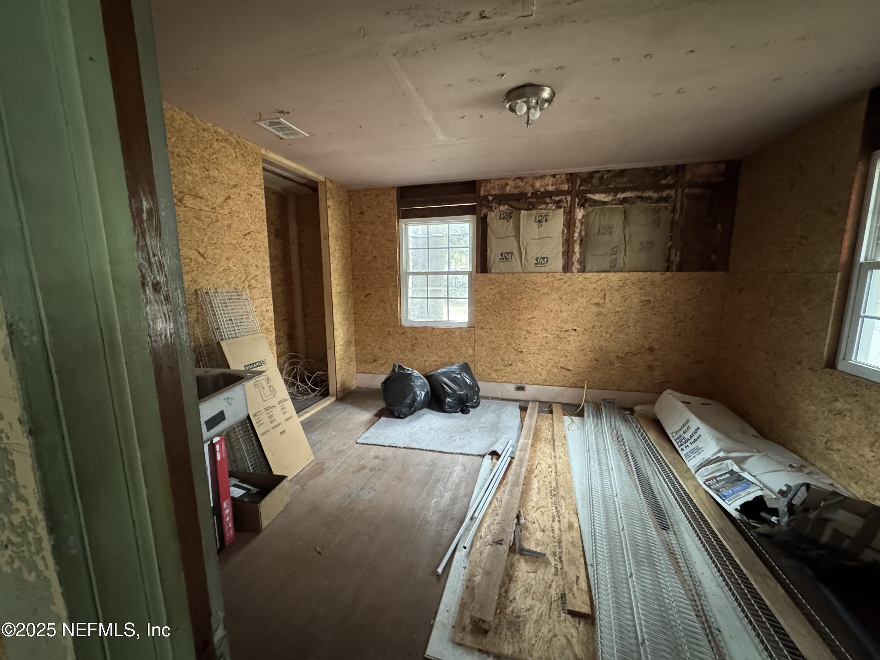 312 South Church Street Starke, FL 32091 - Photo 15 of 18 a bedroom with a bed and a window