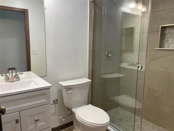 a white toilet sitting next to a bathroom sink