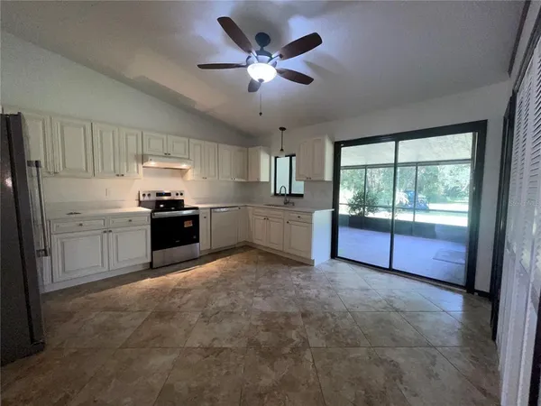 a kitchen with stainless steel appliances granite countertop a stove sink and cabinets