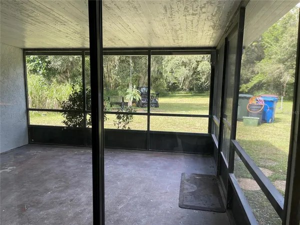 a view of a glass door with a yard
