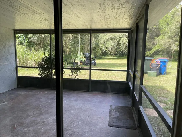 a view of a glass door with a yard