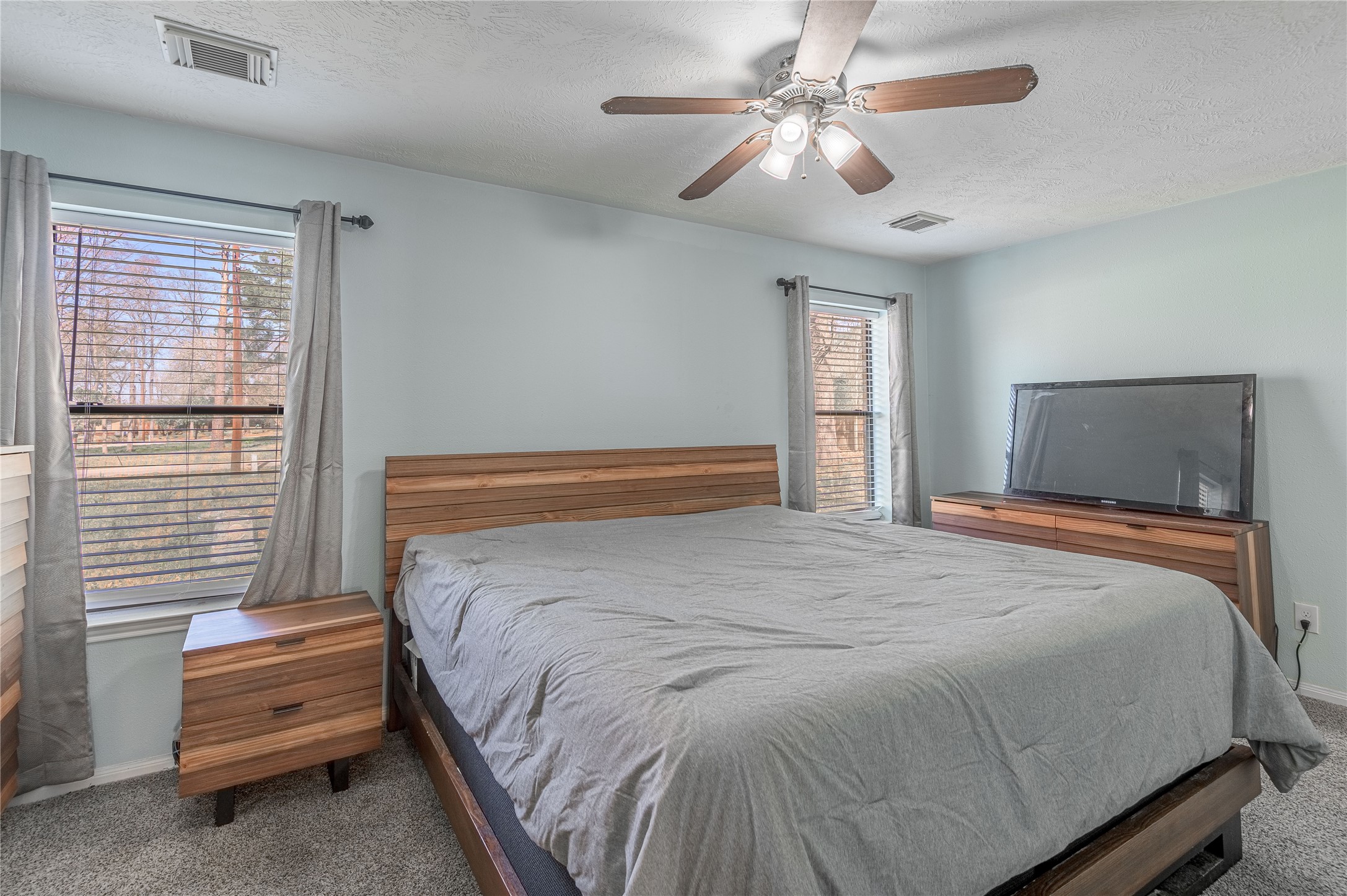 2 Brown Road Huntsville, TX 77320 - Photo 14 of 28 a bedroom with a bed and a chandelier