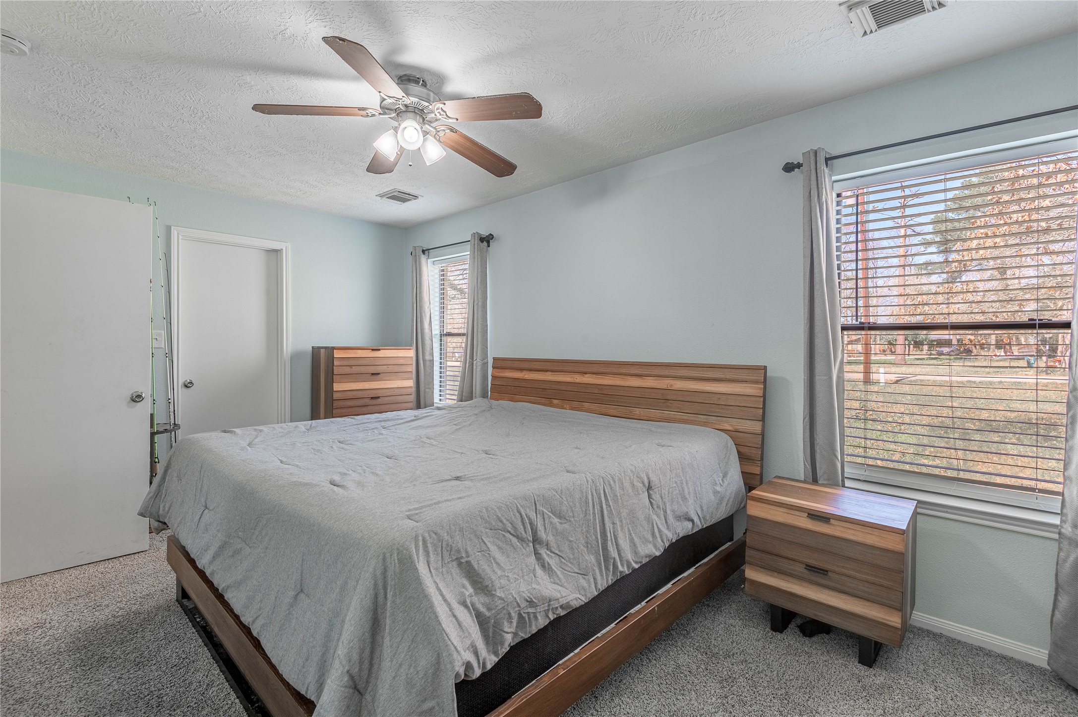 2 Brown Road Huntsville, TX 77320 - Photo 15 of 28 a bedroom with a bed and a ceiling fan