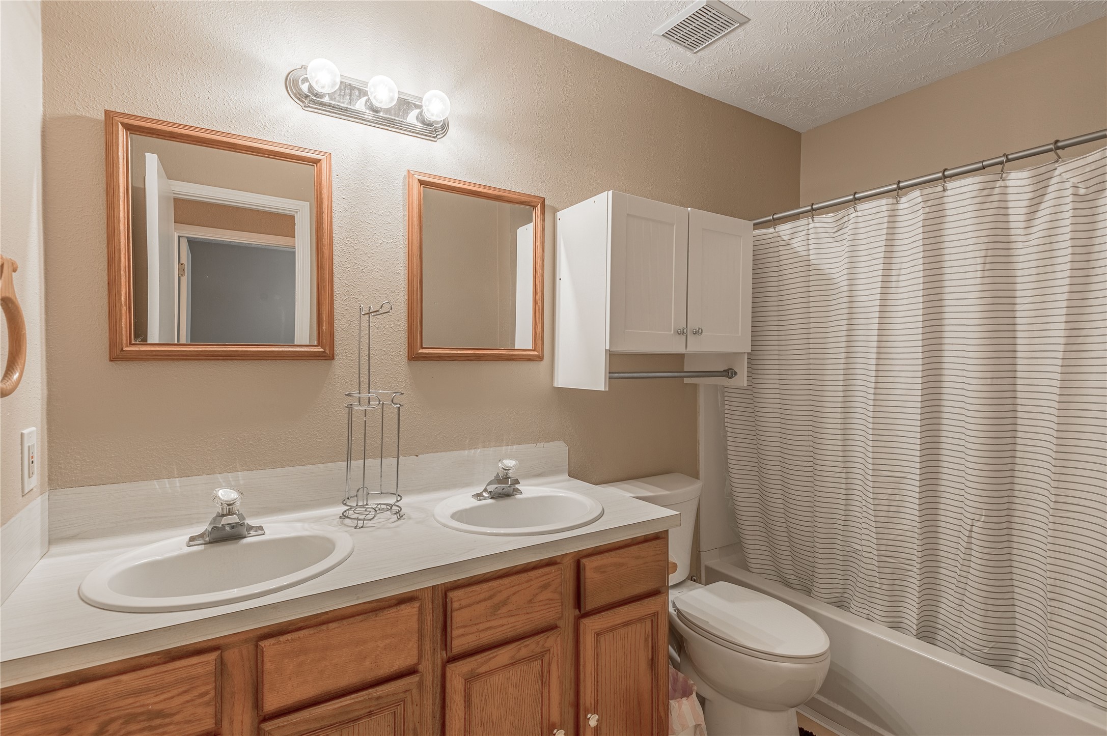 2 Brown Road Huntsville, TX 77320 - Photo 21 of 28 a bathroom with a double vanity sink toilet and a mirror