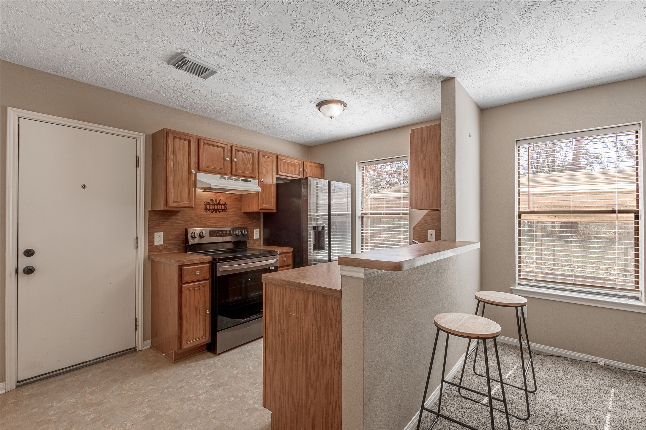 2 Brown Road Huntsville, TX 77320 - Photo 4 of 28 a kitchen with stainless steel appliances granite countertop a stove a sink and a refrigerator