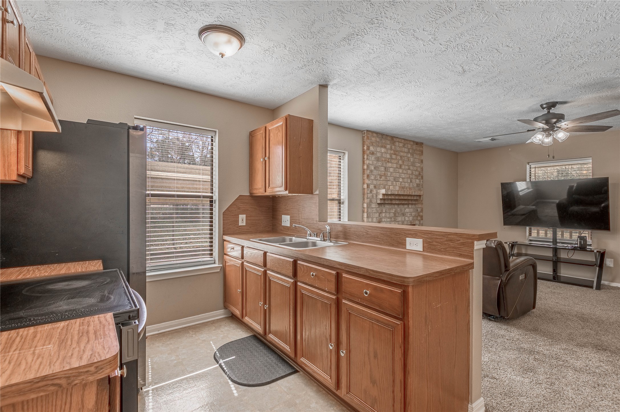 2 Brown Road Huntsville, TX 77320 - Photo 7 of 28 a kitchen with stainless steel appliances granite countertop a sink stove and refrigerator