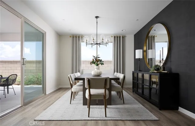 a dining room with furniture a chandelier and wooden floor