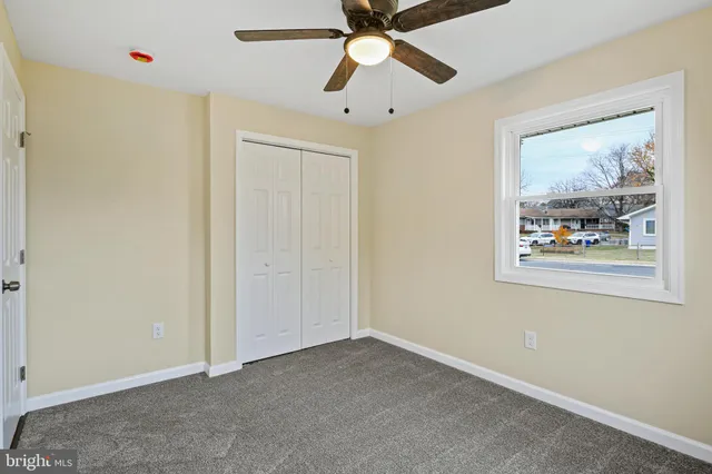 a view of an empty room with closet