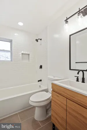 a bathroom with a toilet a sink and bathtub