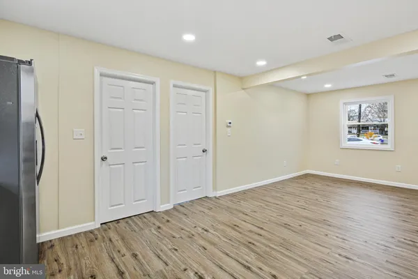 a view of kitchen with wooden floor electronic appliances and window