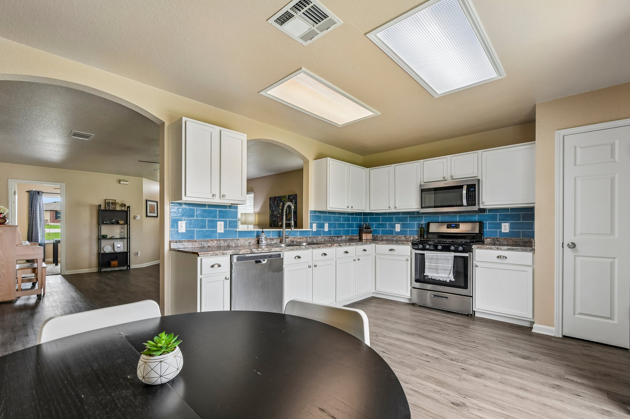 125 Mason Reed Cove Kyle, TX 78640 - Photo 15 of 39 a kitchen with stainless steel appliances granite countertop a sink counter space and cabinets