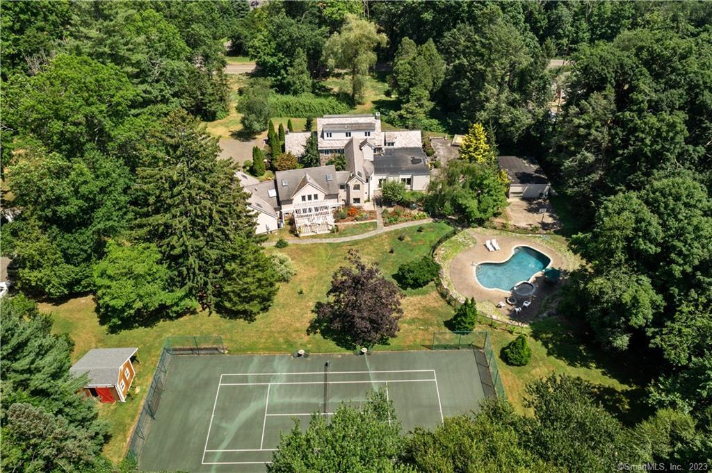 an aerial view of a house with a yard and lake view