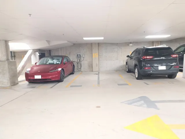 a view of a bike garage with cars