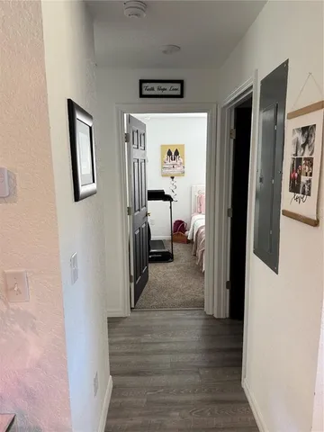 a view of a hallway view with bedroom and wooden floor