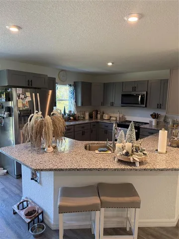 a kitchen with kitchen island granite countertop a table and chairs