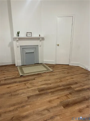 a view of a room with wooden floor