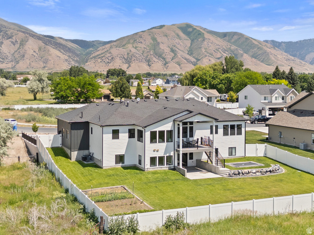 3111 South 1250 West Logan, UT 84321 - Photo 49 of 51 Modern two-story residence featuring a dark shingled roof and contrasting white and dark gray siding