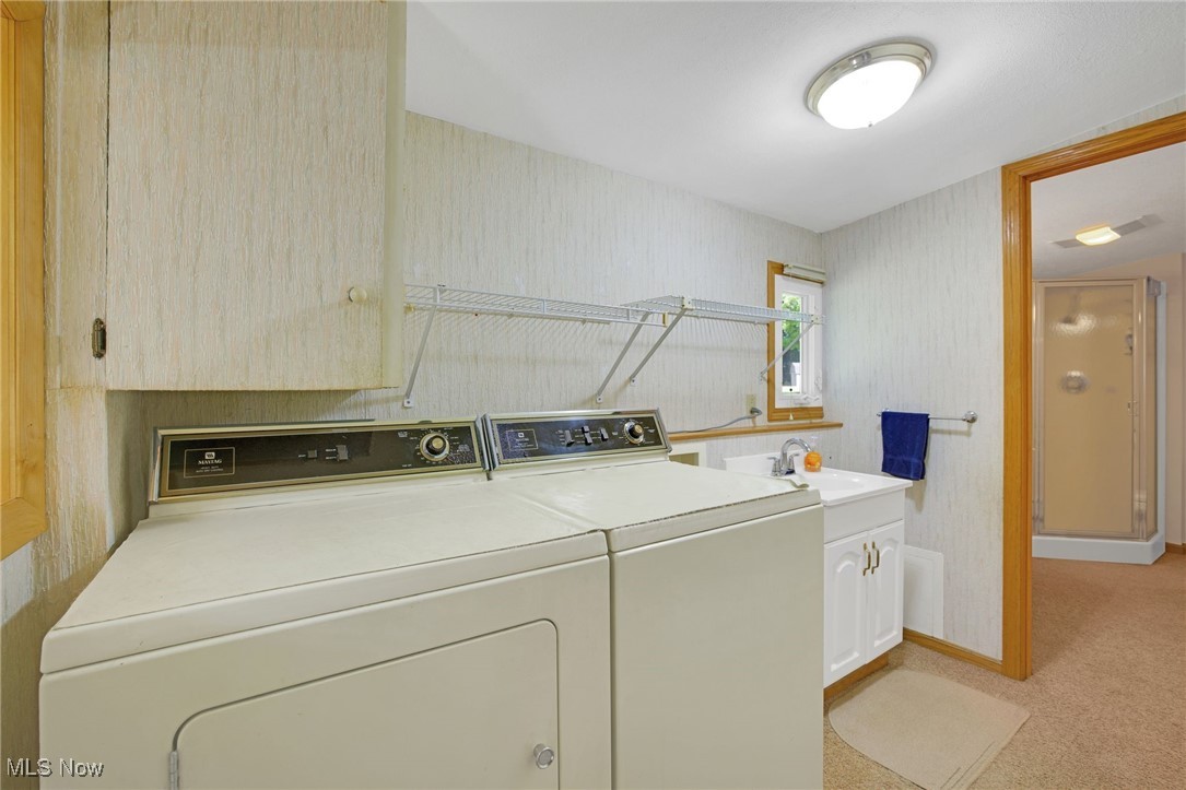 260 Trease Road Wadsworth, OH 44281 - Photo 25 of 30 Laundry room featuring washing machine and dryer, cabinet space and sink located on first floor