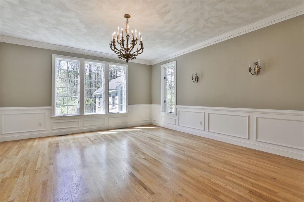 5 Stanton Circle Boxford, MA 01921 - Photo 11 of 42 a view of an empty room with a window and wooden floor