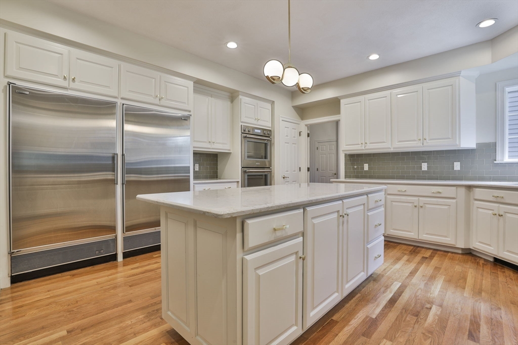 5 Stanton Circle Boxford, MA 01921 - Photo 12 of 42 a kitchen with kitchen island granite countertop a sink cabinets and wooden floor