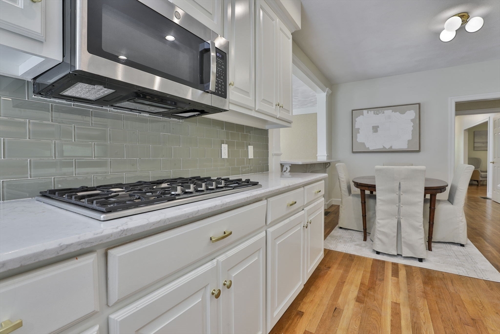 5 Stanton Circle Boxford, MA 01921 - Photo 14 of 42 a kitchen with stainless steel appliances a stove a sink and white cabinets