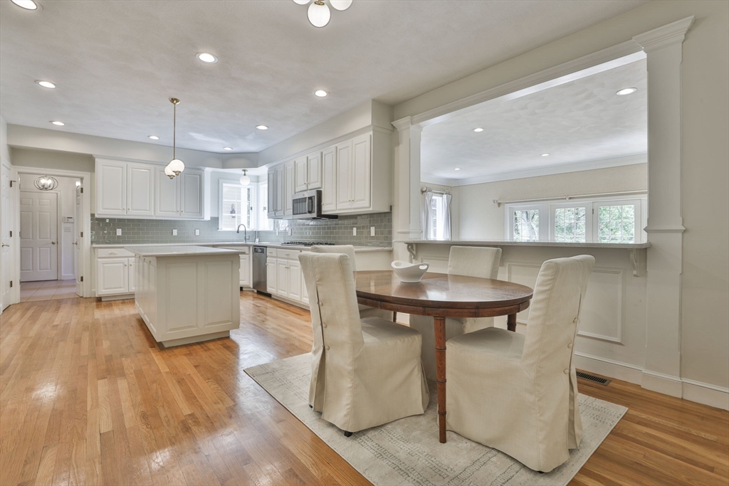 5 Stanton Circle Boxford, MA 01921 - Photo 16 of 42 a kitchen with stainless steel appliances granite countertop a sink a stove a refrigerator and island with wooden floor