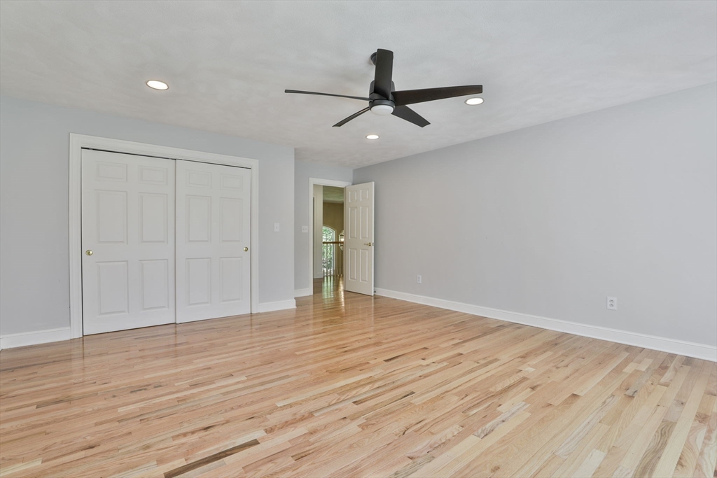 5 Stanton Circle Boxford, MA 01921 - Photo 35 of 42 a view of an empty room with wooden floor and a ceiling fan