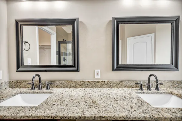 a bathroom with a granite countertop sink a mirror and a window