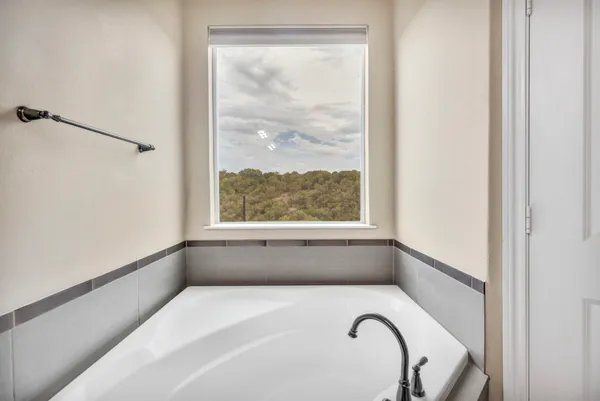 a bathroom with a bath tub and a window