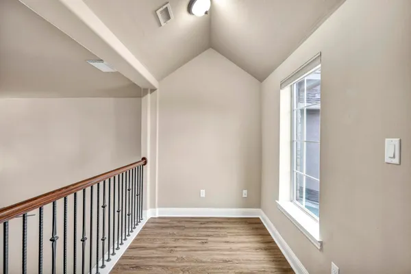 a view of a hallway view with wooden floor and staircase