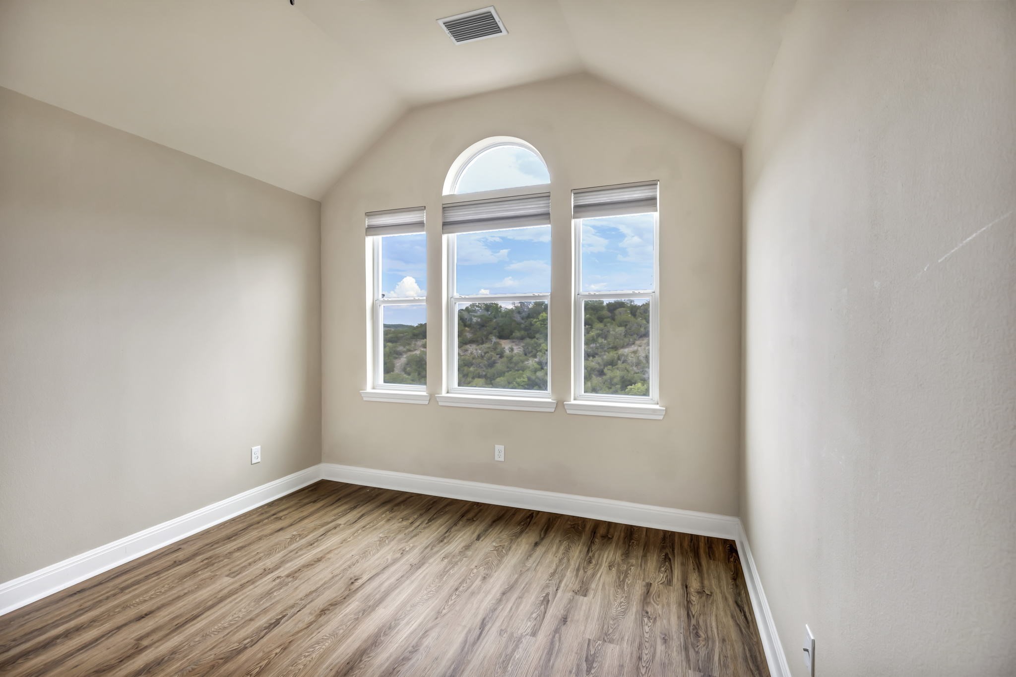 206 Sunrise Ridge Cove Austin, TX 78738 - Photo 19 of 38 an empty room with wooden floor and a window